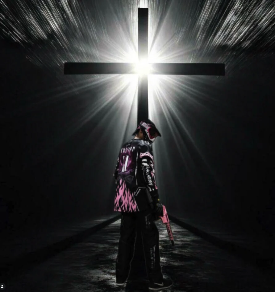 Disciples Airsoft player beneath a cross